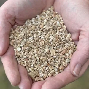 Close-up texture of vermiculite granules used for moisture retention in potting mix